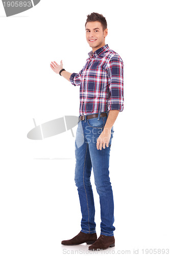 Image of young man in casual clothes presenting