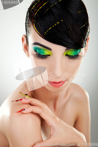 Image of woman with  bright manicure and makeup
