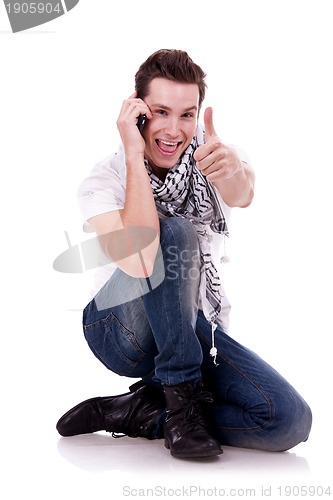 Image of talking on the phone and  making the ok