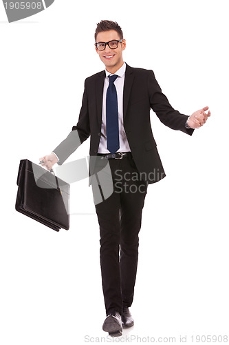 Image of young business man walking and welcoming