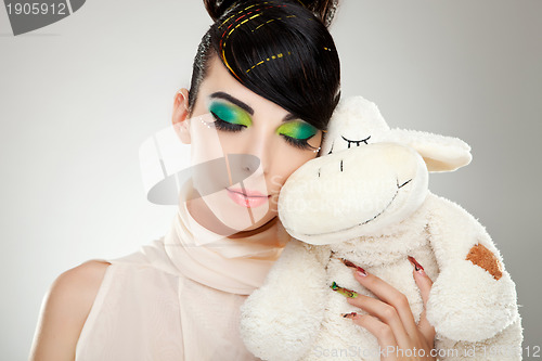 Image of Fashion girl posing with teddy 