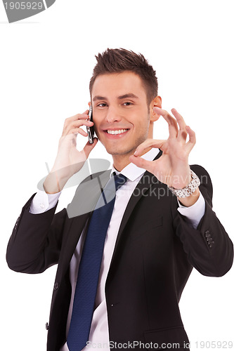 Image of business man on the phone approving