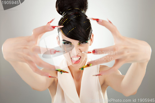 Image of angry brunette girl shows her finger nails