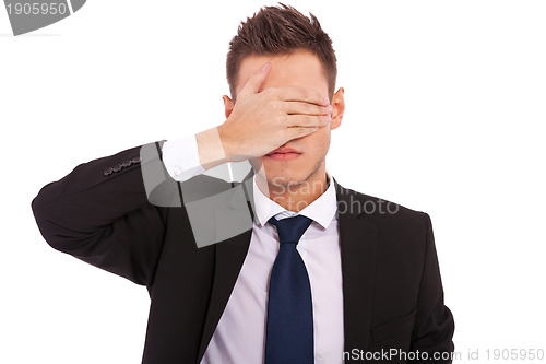 Image of business man making the see no evil gesture 