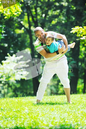 Image of happy father and son have fun at park