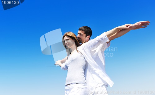 Image of happy young couple have fun on beach