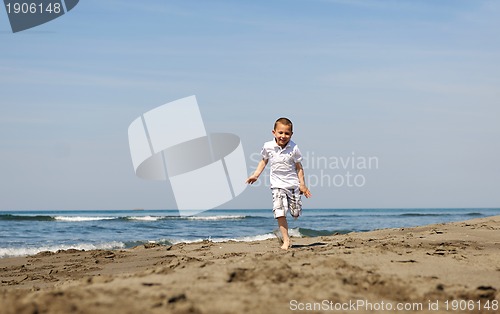 Image of little boy running on beach