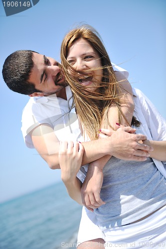 Image of happy young couple have fun on beach