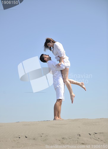 Image of happy young couple have fun on beach