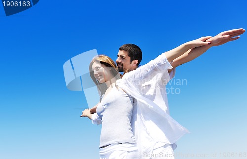 Image of happy young couple have fun on beach