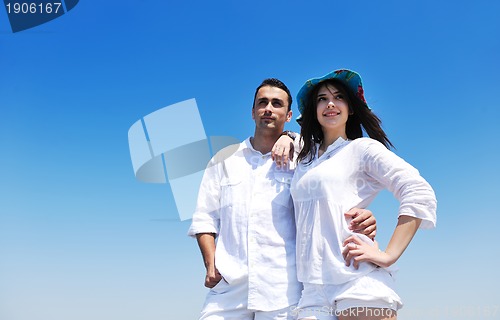 Image of happy young couple have fun on beach