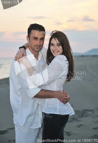 Image of happy young couple have fun on beach