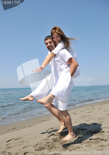 Image of happy young couple have fun on beach