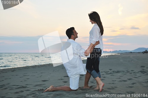 Image of happy young couple have fun on beach