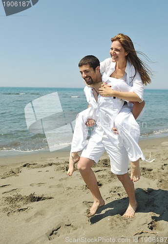 Image of happy young couple have fun on beach