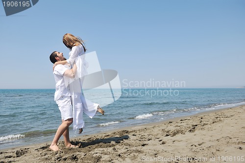 Image of happy young couple have fun on beach