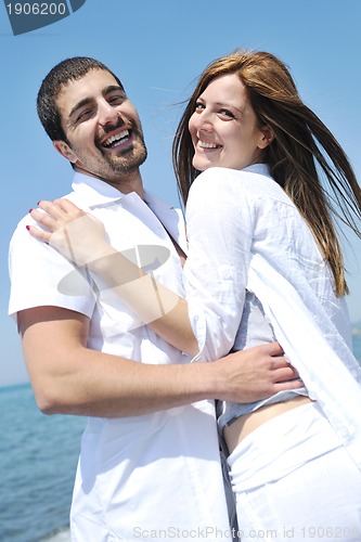 Image of happy young couple have fun on beach