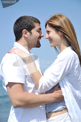 Image of happy young couple have fun on beach