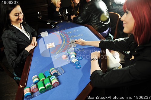 Image of woman play black jack card game in casino