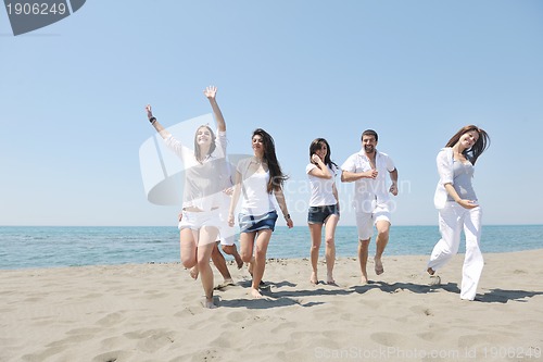 Image of Group of happy young people in have fun at beach