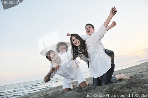 Image of happy young family have fun on beach