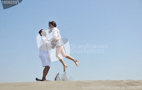 Image of happy young couple have fun on beach