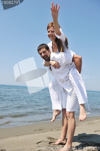 Image of happy young couple have fun on beach