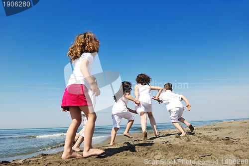 Image of happy child group playing  on beach