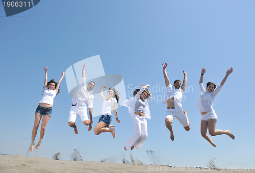 Image of happy people group have fun and running on beach