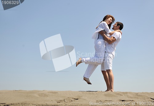Image of happy young couple have fun on beach