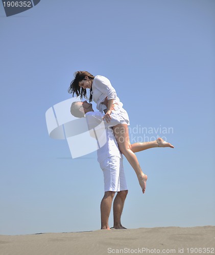 Image of happy young couple have fun on beach