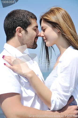 Image of happy young couple have fun on beach