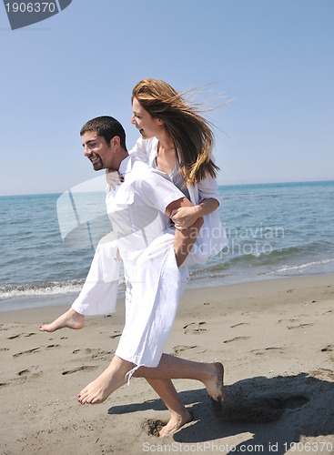 Image of happy young couple have fun on beach
