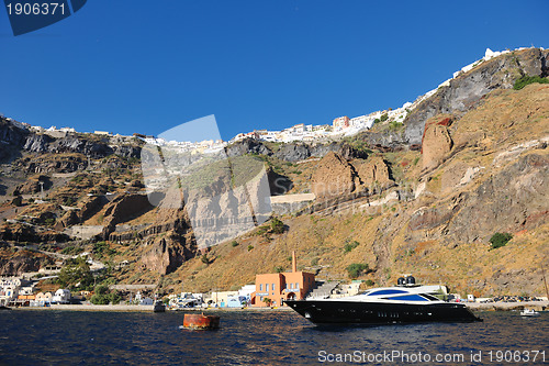 Image of santorini island coast with luxury yacht