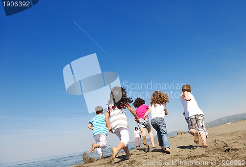 Image of happy child group playing  on beach
