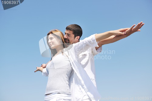 Image of happy young couple have fun on beach