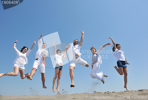 Image of happy people group have fun and running on beach
