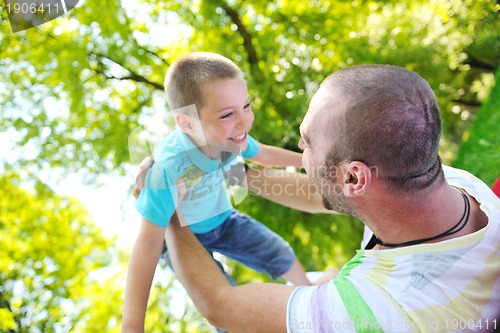 Image of happy father and son have fun at park