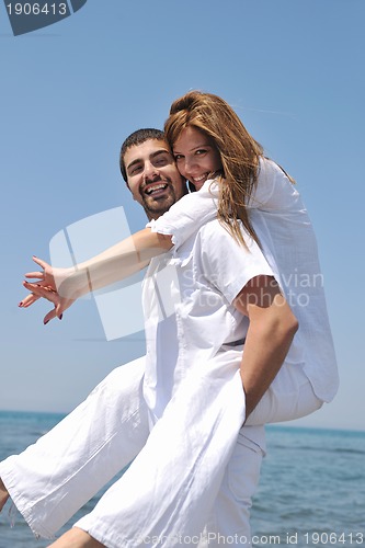 Image of happy young couple have fun on beach