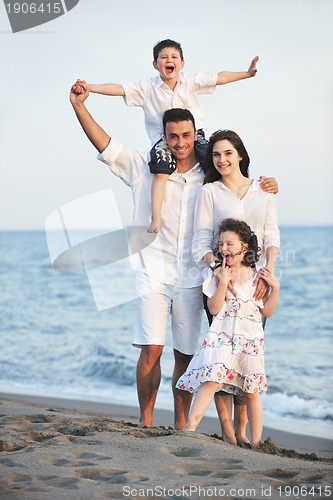 Image of happy young family have fun on beach