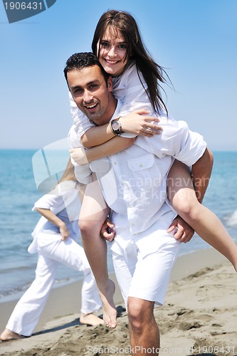 Image of happy young couple have fun on beach