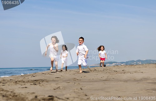 Image of happy child group playing  on beach