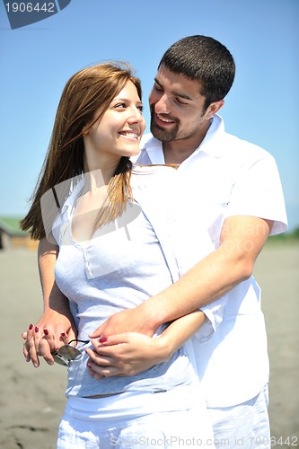 Image of happy young couple have fun on beach
