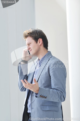 Image of young business man alone in conference room