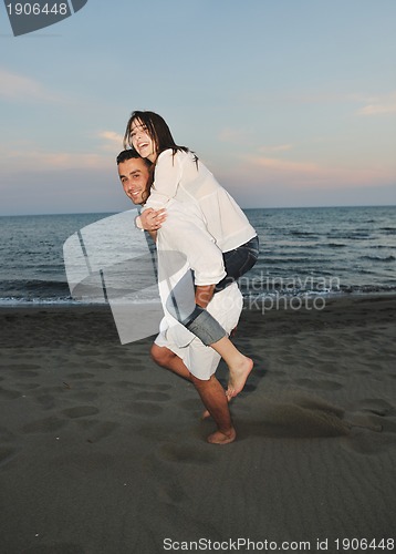 Image of happy young couple have fun on beach