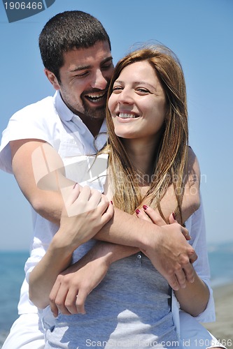 Image of happy young couple have fun on beach