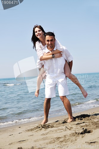 Image of happy young couple have fun on beach