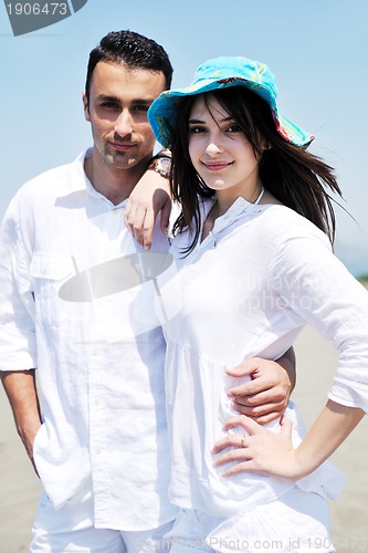 Image of happy young couple have fun on beach