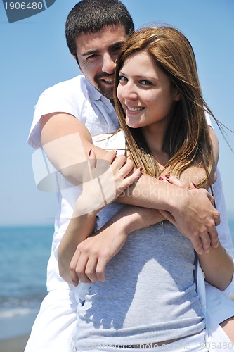 Image of happy young couple have fun on beach