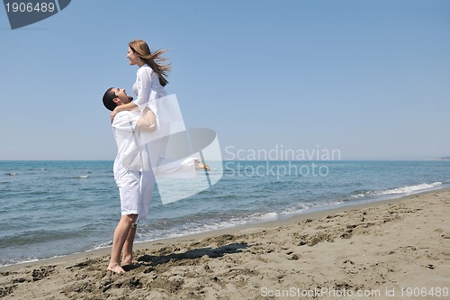 Image of happy young couple have fun on beach